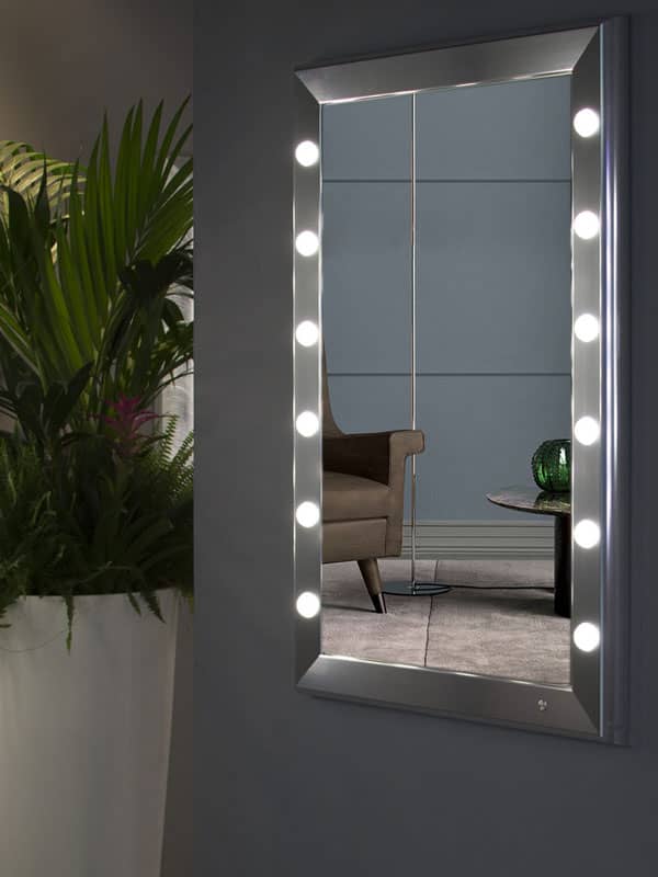 Silver framed mirror with lights in living room