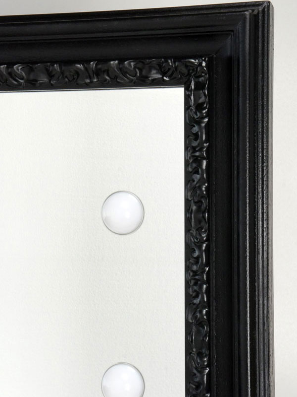 black framed mirror with lights