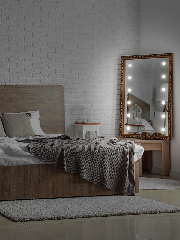 Large wooden mirror with lights in bedroom